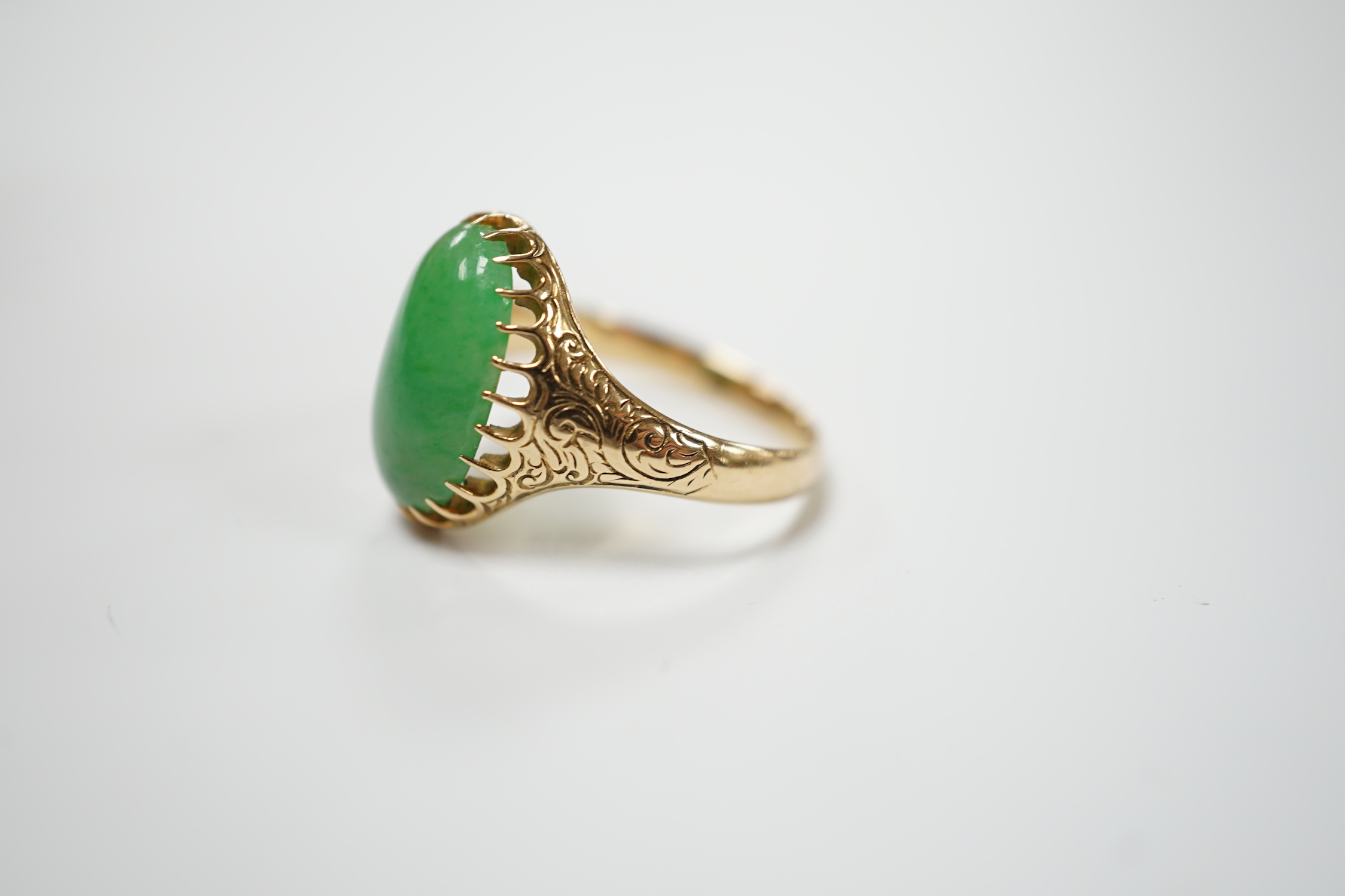 A yellow metal (stamped 18) and single stone cabochon jade set ring, size Q, gross weight 5.7 grams.